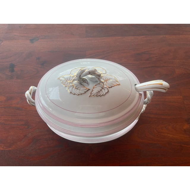 Here is a large tureen with a lid, under-plate and ladle, possibly associated with the historical china production in the...