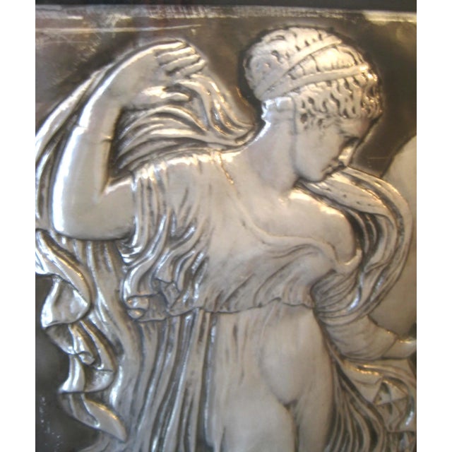 French embossed silver tile with angel figure, possibly originally from a building. Has beveled glass mirror inside black...