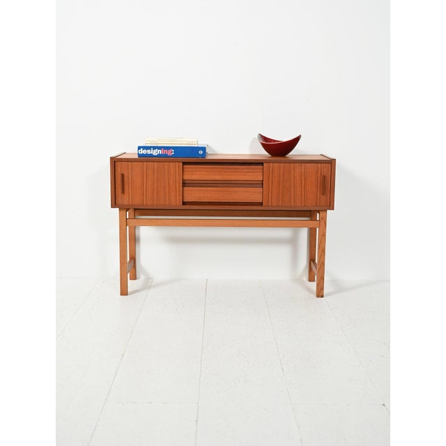 Scandinavian teak and oak cabinet from the 1950s–1960s, with sliding doors and central drawers, featuring light and simple...