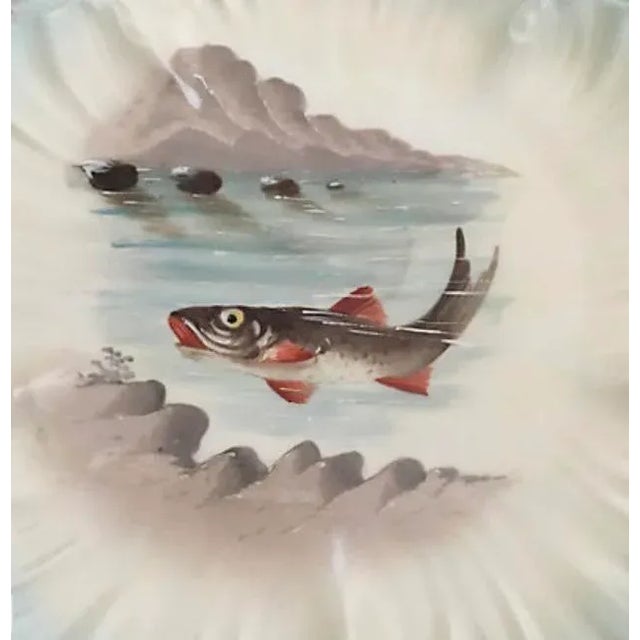 Set of ten hand painted porcelain Limoges fish plates. Signed "Limoges France."