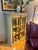 A very cool bookcase with 3 adjustable shelves and doors that have a unique latching mechanism. Distressed paint for a...