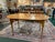 This exceptional dining table by J.L. Treharn & Co. is crafted from solid tiger maple, celebrated for its striking flame-...