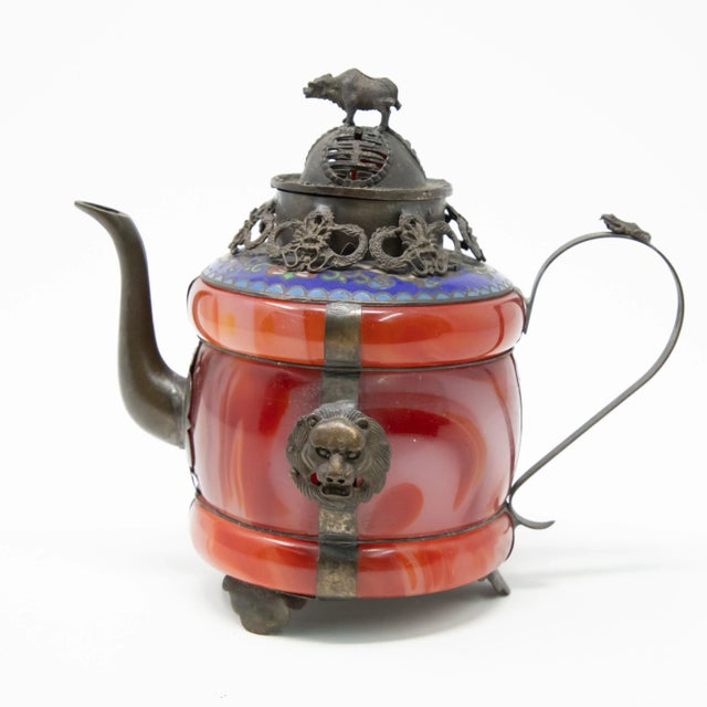 Offering this unmatchable Chinese teapot made of carnelian stone with enameled bronze and filigree. Starting on a footed...