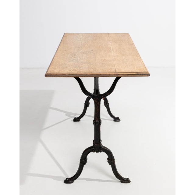 A striking example of early 20th-century French industrial craftsmanship, this bistro side table pairs the robust solidity...