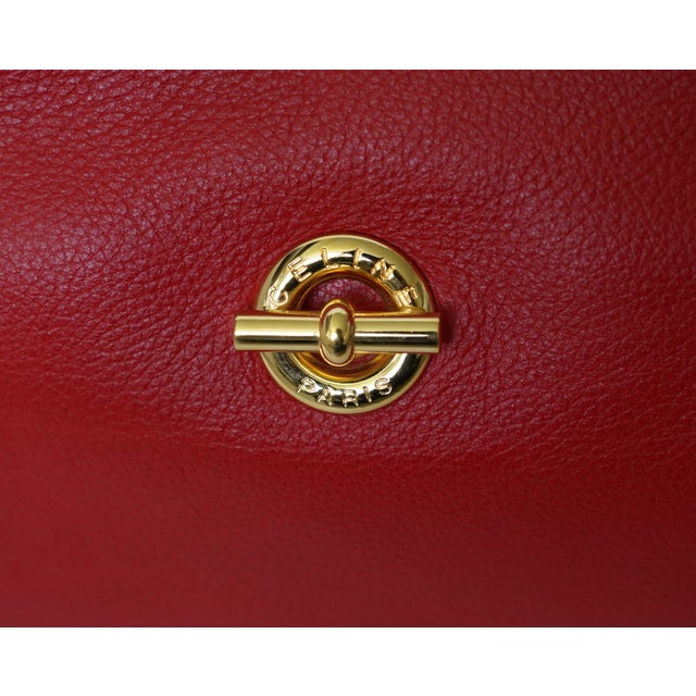 A beautifully crafted authentic Celine vanity cosmetic case in rich red pebbled lambskin leather, finished with elegant...