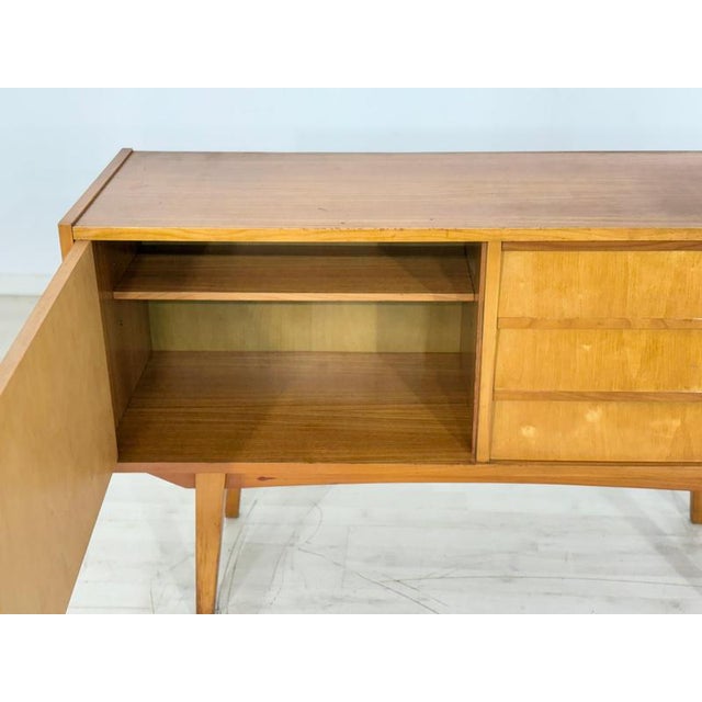 Beautiful vintage sideboard from the 1960s. This piece of furniture impresses with its clean lines, elegant wood grain,...