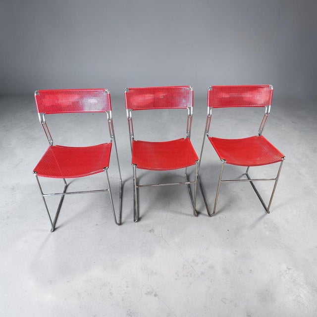 Striking set of three vintage modern stacking chairs dating to approximately the 1970s–early 1980s. Each chair features a...