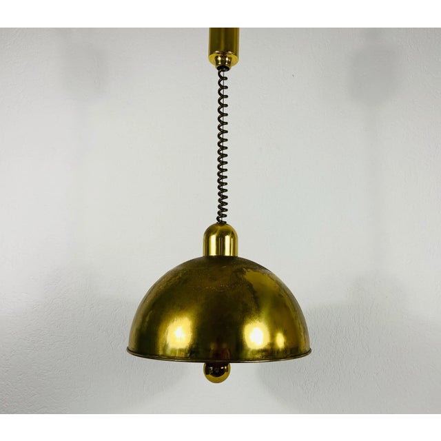 Brass pendant lamp by WKR made in Germany in the 1970s. It is fascinating with its exclusive design. The height of the...