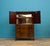 A mid century mahogany Beithcraft drinks cabinet or linen cabinet There's a cupboard with a mirror back and shelf, along...