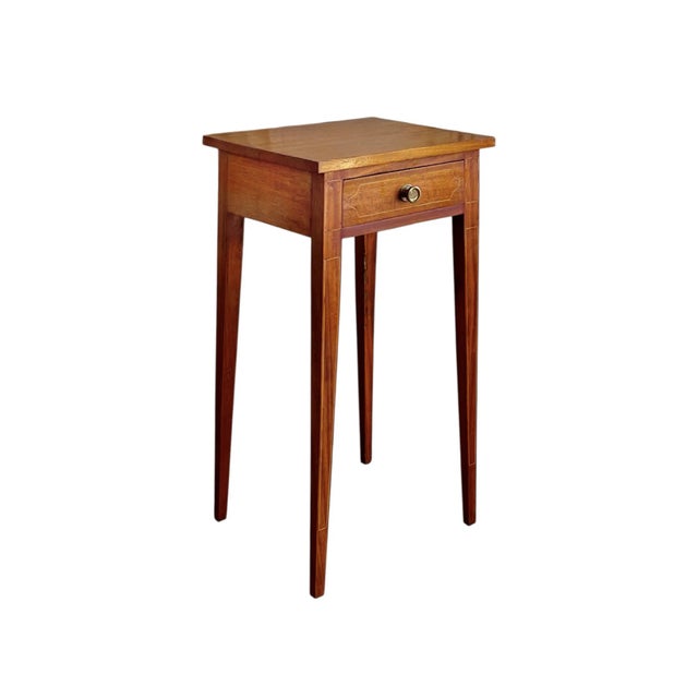 A rare pair of period English Hepplewhite side tables crafted of mahogany and inlaid with boxwood. Each consists of single...