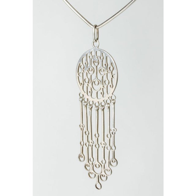 Beautiful silver neckring by Marianne Berg, with a large kinetic pendant in a folkloristic design. Looks great with a...