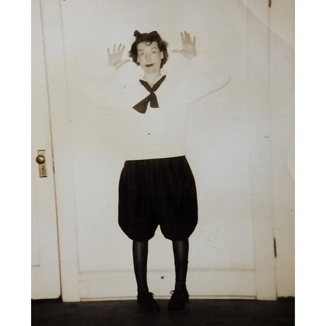 Vintage c. 1920's snapshot photograph of a women in a costume that looks like Minnie Mouse. She is standing in front of a...