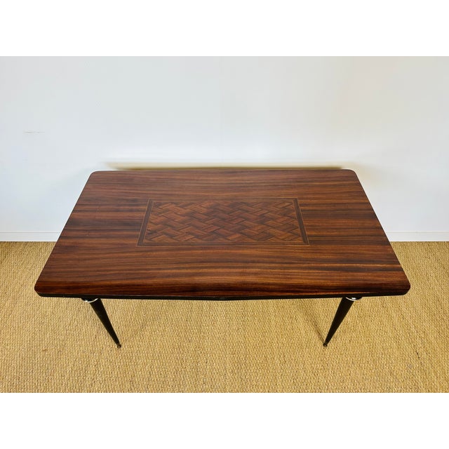 Art deco macassar dining table dating from the 1940s. Possibility of adding two extensions. Dimensions: H76.5 L158.5 D92
