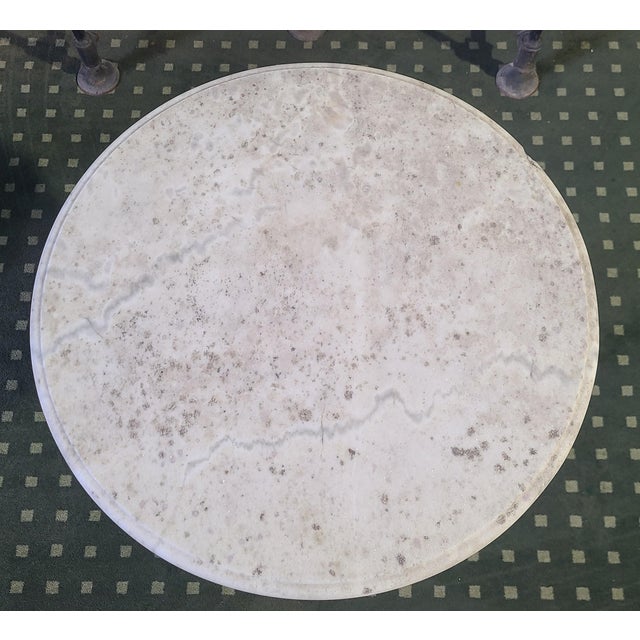 Cast iron and steel side table with a marble top
