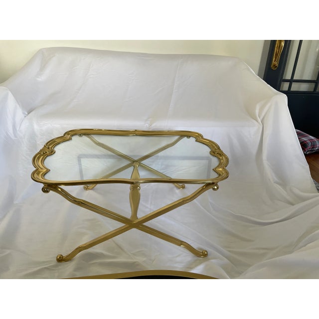 Stunning Brass and Glass Coffee or Drinks Table. Scalloped Edge glass top with fleur-de-lis detail. X base. Heavy. In the...