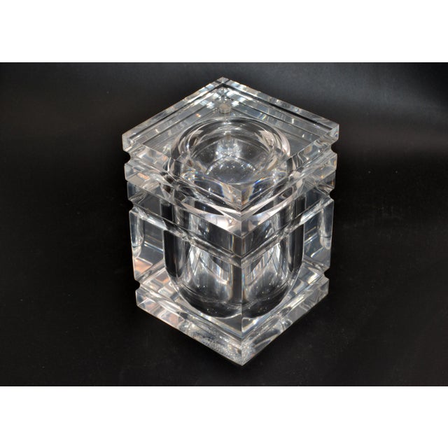 Mid-Century Modern finely detailed ice bucket in Lucite. The tight fitted lid swings open and is attached to the bucket....
