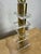 Striking vintage table lamp featuring a polished brass column accented by graduated clear Lucite platforms. Its tall,...