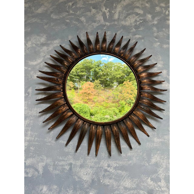 This large Spanish round copper plated mirror from the 1950s boasts a wonderfully proportioned mid century sunburst design...