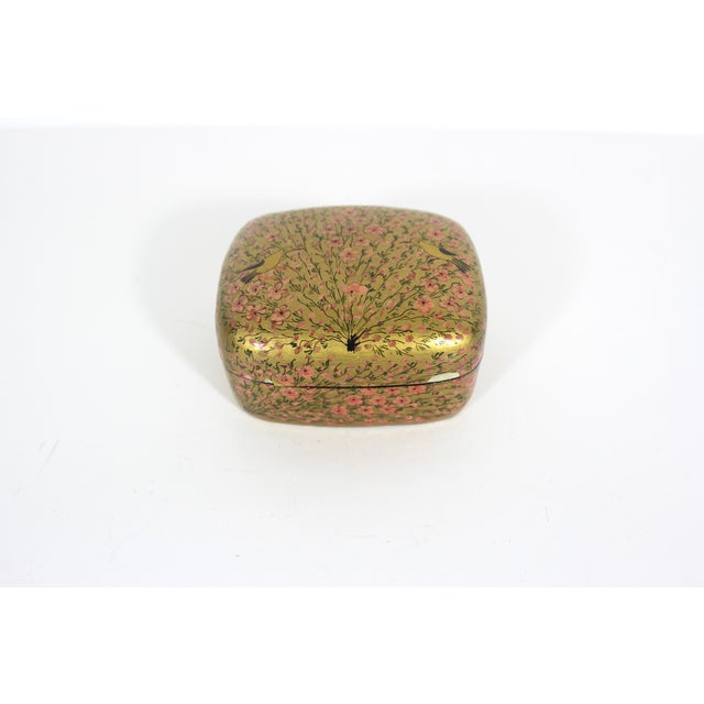 Beautiful vintage Kashmir lidded round trinket box made from papier maché, hand painted and then lacquered. This has a...