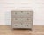 A refined Swedish Gustavian-style chest of drawers. Crafted in pine, this piece is painted in a soft blue tone, a color...