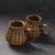 A pair of vintage-style ceramic mugs, designed in the shape of pumpkins with fluid, sculptural lines.