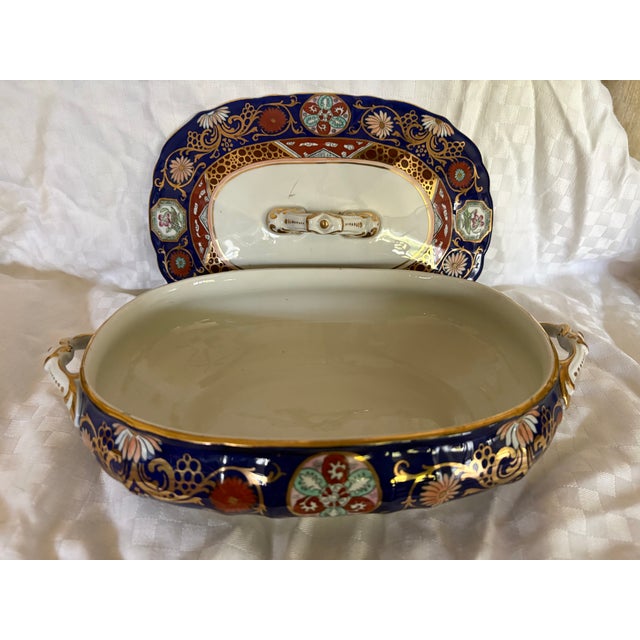 An early 19th C Imari pattern Mason's ironstone covered tureen. The piece is painted overall in cobalt blue with a series...
