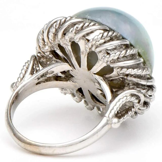 Feel chic wearing this large, Mabe pearl ring with a beautiful 14K white gold braided setting. The pearl features an...