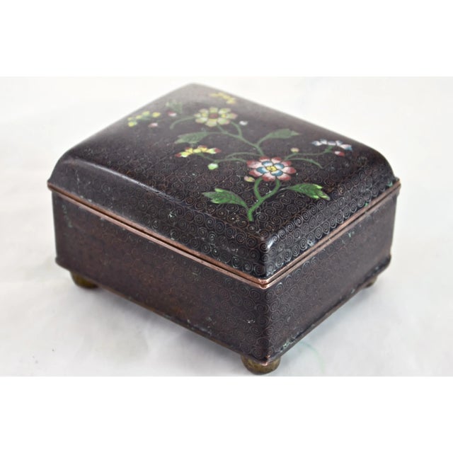 Intricate Chinese cloisonne enamel hinged copper box with ball feet hand decorated in a vivid yellow, teal blue, pink, red...