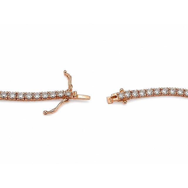 Timeless in form and dramatic in scale, this 10K Rose Gold tennis necklace is set with round lab-grown diamonds in a...