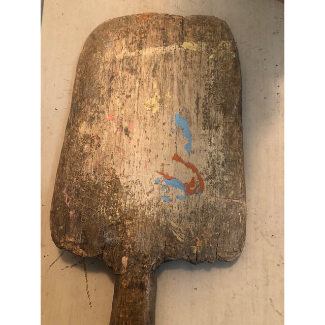 small rustic board with paint on one side, probably used in a household project The board has a hanger that can be hung on...