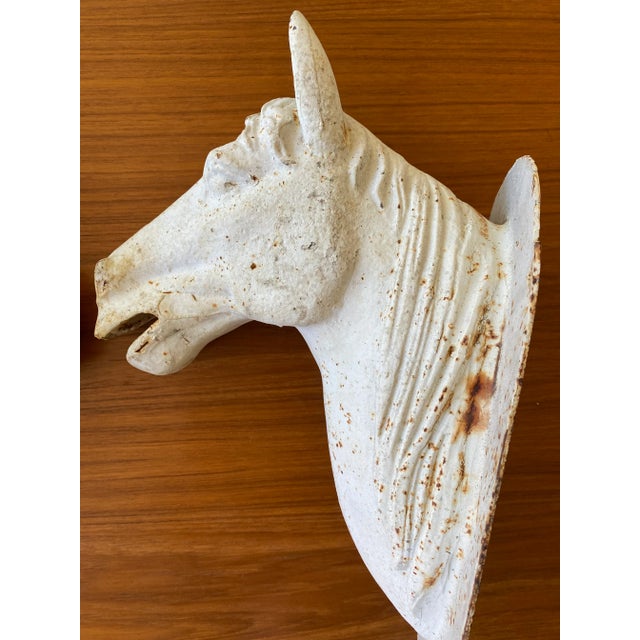 Late 19th century cast iron horse head bust with wall plate for mounting. Wonderful rustic patina with chippy white paint...