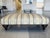 A vintage George Smith ottoman, hand-crafted with a pale yellow striped linen upholstery, brass studs, and turned mahogany...