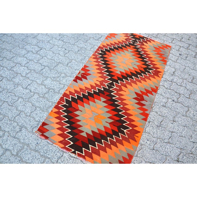 This is a vintage Turkish Oushak rug from the 1960s. The piece was hand-knotted.