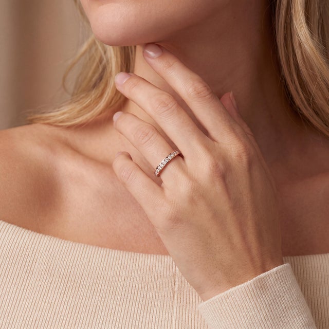 A classic late-20th-century wedding ring. Crafted in 14k gold, this band features a continuous row of natural brilliant-...