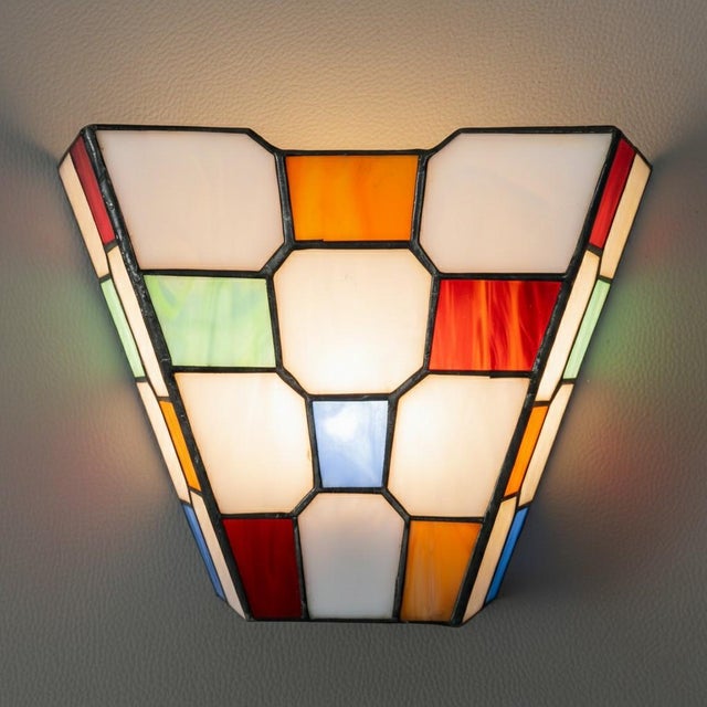 A magnificent and rare wall light that embodies the timeless charm of 20th-century craftsmanship. This splendid 1970s wall...