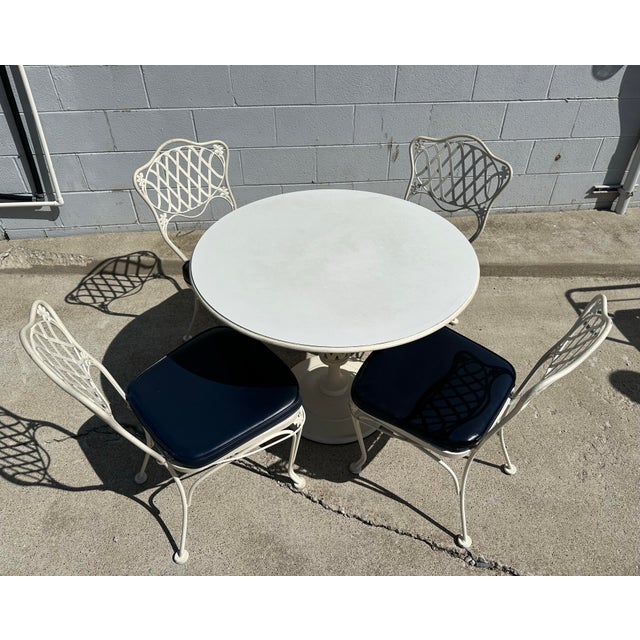 Super clean Woodard Florentine patio table and 4 chairs. Table top has a laminate top for easy clean up. Table measures...
