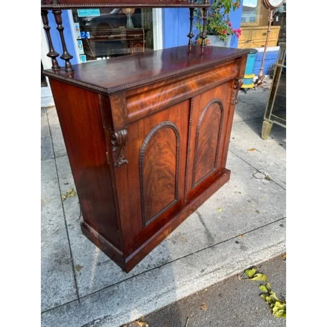 This is a very nice English Mahogany Chiffonier with shelves above. Very intricately carved shelves above open fretwork. A...