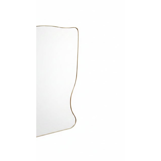 Midcentury Italian wall mirror with brass frame (circa 1950s). The mirror is shield-shaped, classically elegant and a...