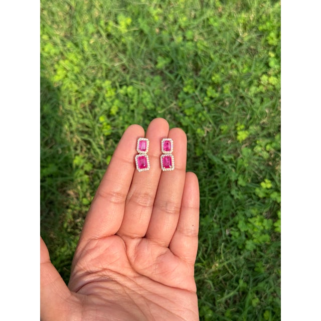 These elegant 3.03 carat emerald-cut ruby and diamond double drop earrings are crafted in 14K yellow gold. Each ruby...