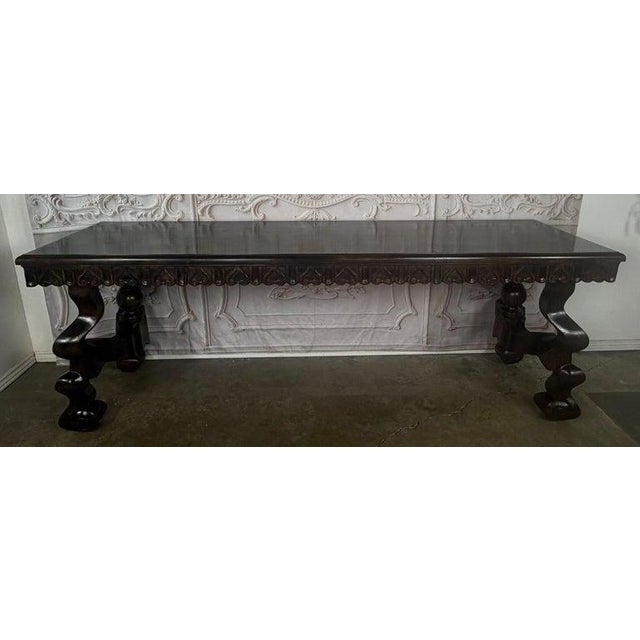 A dramatic and sculptural Spanish Revival console table, exuding old-world grandeur and master craftsmanship. The piece...