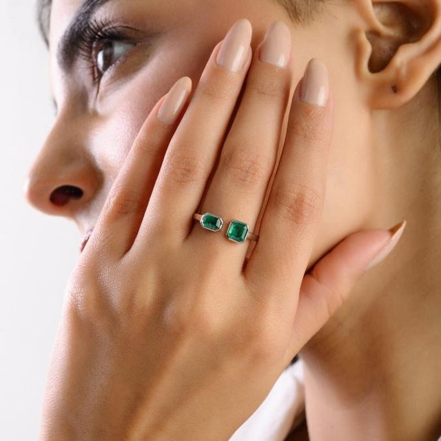 This elegant Modern Toi et Moi ring feature 2 octagon cut emeralds totaling 0.84 carats, set in rich 18K white gold and...