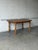 This fixed oval dining table features a broad top and a robust base. The silhouette is elevated by beautifully detailed...