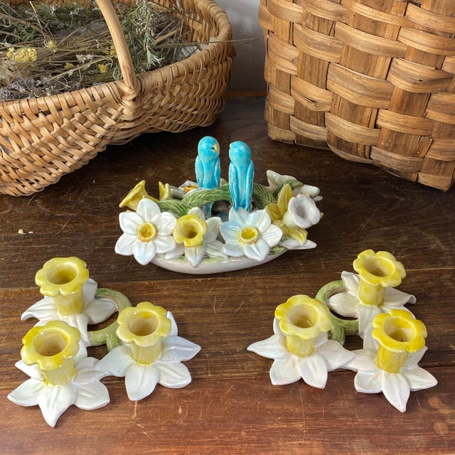 A charming set of slipware (perfect for table decoration) consisting of: A three-candle holder decorated with flowers and...