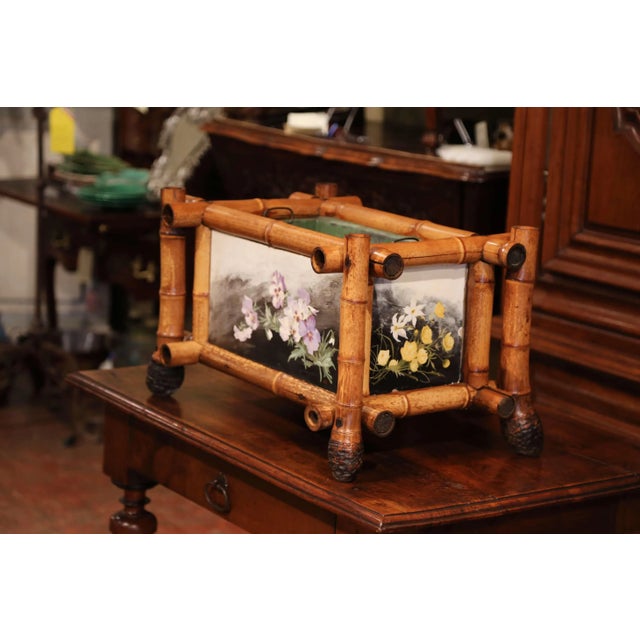 This charming antique French jardinière combines the warm character of natural bamboo with delicately hand-painted floral...