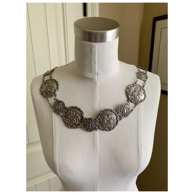 A fine Victorian silver plate angel figural plaque belt with angel cherub figural plaques dating to the Victorian era....