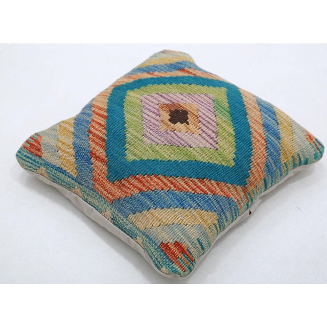 A one-of-a-kind handwoven Afghan wool kilim accent pillow featuring concentric diamond medallion. Cut and sewn by hand...