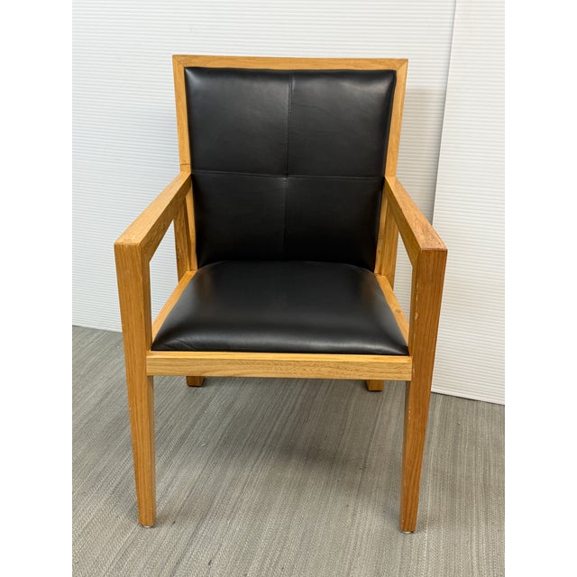 Design Plus Gallery Presents Maria Yee black leather arm chair. Made of solid wood Ash pieces. Its cover is top Grain...