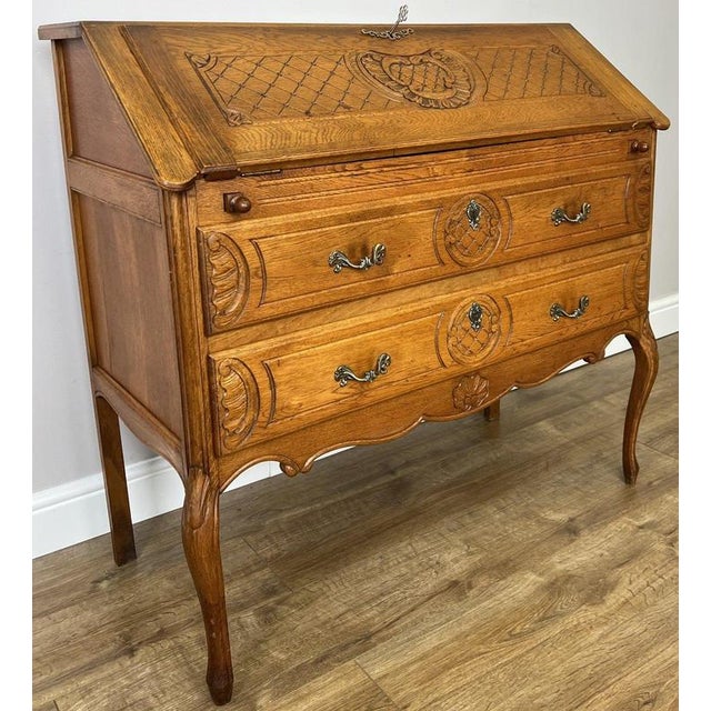 A charming vintage French Louis writing bureau cabinet, combining elegant craftsmanship with practical functionality. The...