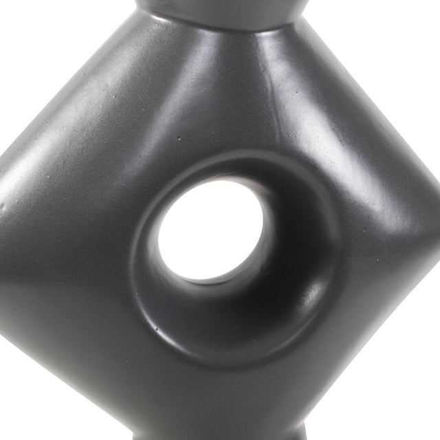 A captivating piece that stands as its own visual masterpiece. Crafted in matte black, this vase features a sharp square...
