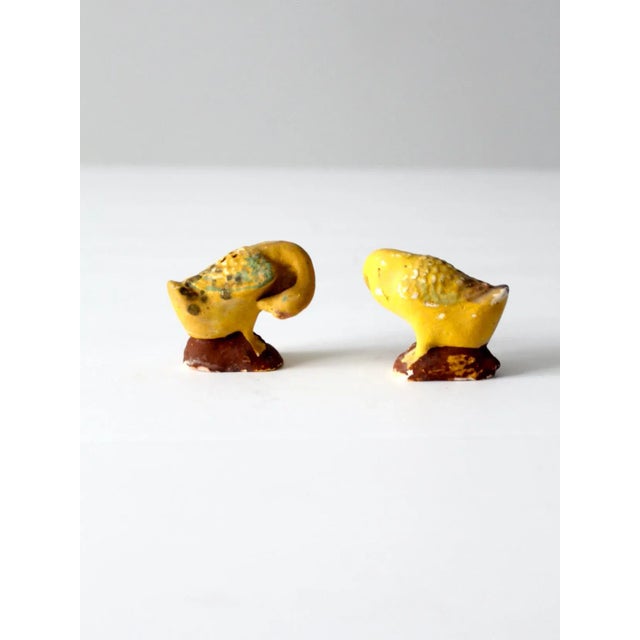 A pair of vintage figural bird salt and pepper shakers, formed with softly rounded bodies and perched on small bases. The...